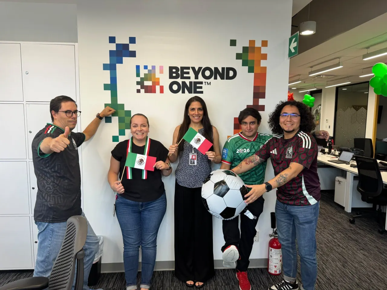 The Mexico City team holding flags and a football in front of the Beyond ONE logo