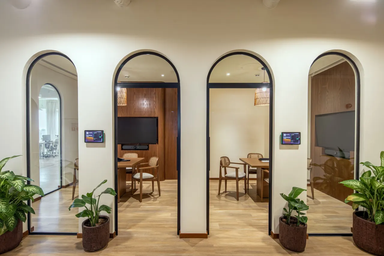 Meeting rooms behind arched glass doors at the Riyadh office